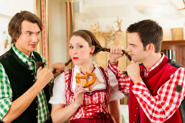 People in traditional Bavarian Tracht in restaurant or pub — стокове фото