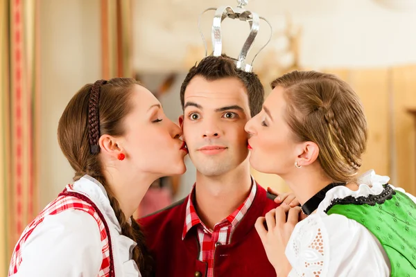 People in traditional Bavarian Tracht in restaurant or pub — стокове фото