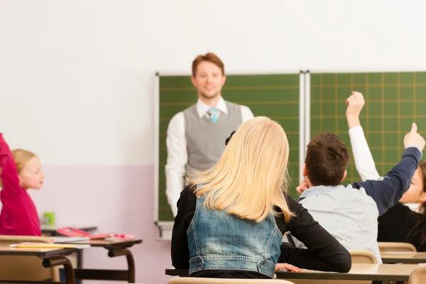 Education - Teacher with pupil in school teaching — Stock Photo, Image