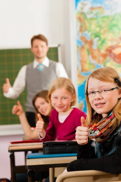 Education - Teacher with pupils in school teaching — ストック写真