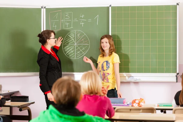 Education - teacher with pupils in school teaching — 图库照片