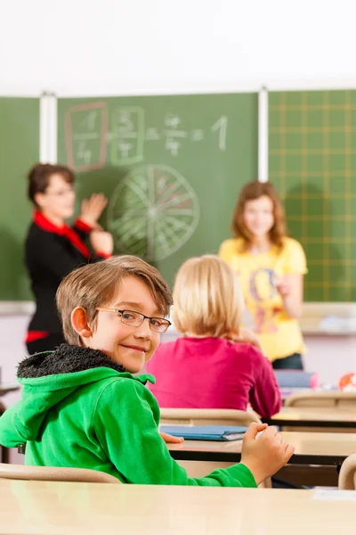 Education - teacher with pupils in school teaching — ストック写真