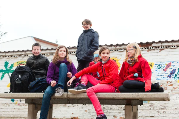 Pupils at schoolyard of their school — Stock Photo, Image