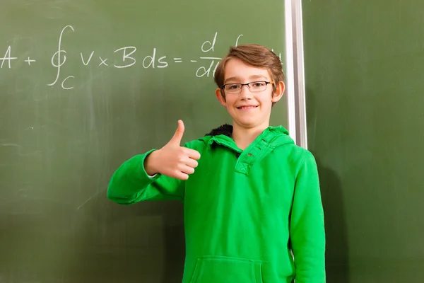Education - Child or pupil at blackboard in school — Stock Photo, Image
