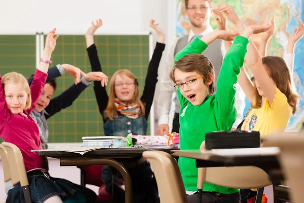 Education - Pupils and teacher learning at school — Stock Photo, Image