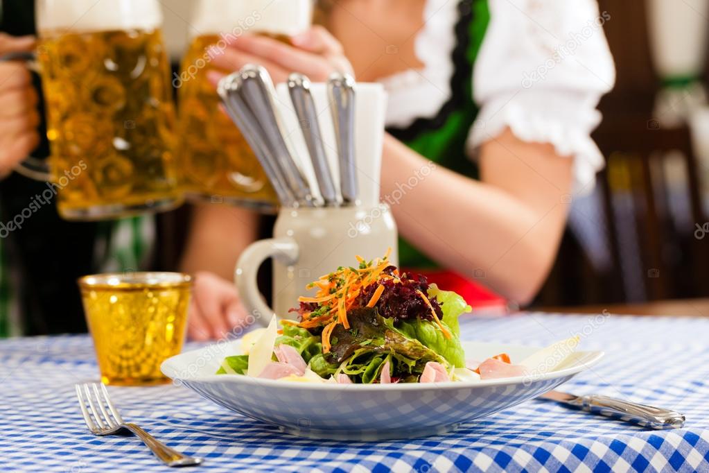 woman in traditional Bavarian Tracht in restaurant or pub