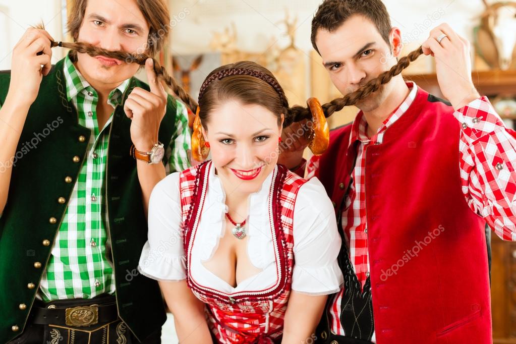 People In Traditional Bavarian Tracht In Restaurant Or Pub Stock Photo