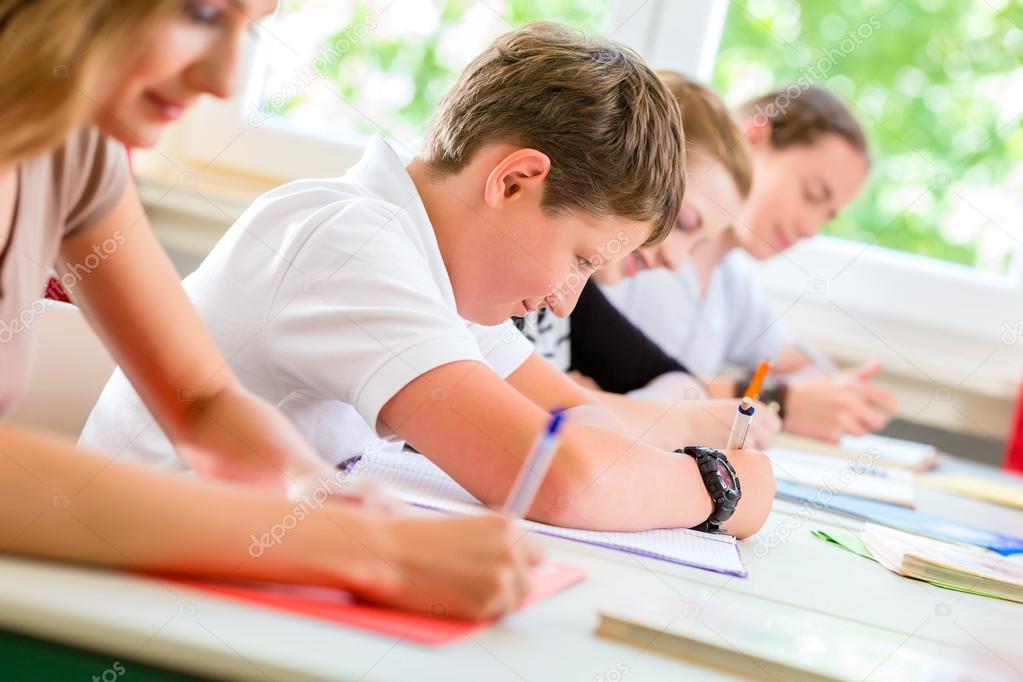 Students writing a test in school concentrating