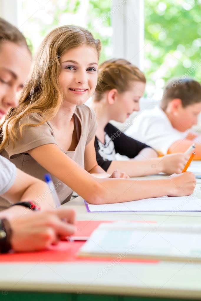 Students writing a test in school concentrating