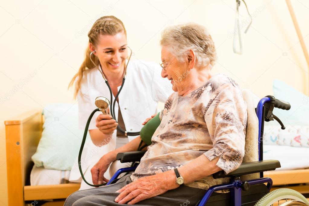 nurse and female senior in nursing home