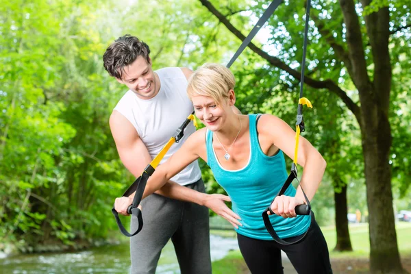 Mensen in park op opschorting of sling trainer — Stockfoto