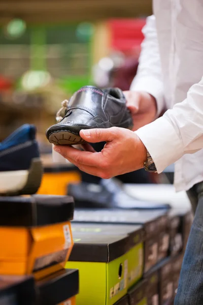 Customer Holding Stylish Shoe at Supermarket — Stock Photo, Image