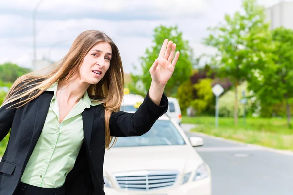 Молодая деловая женщина вызывает такси — стоковое фото