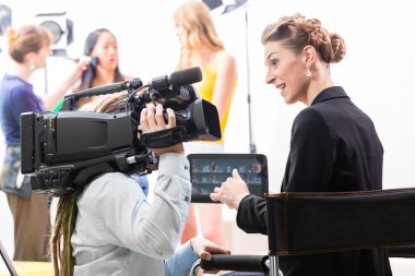 Director giving cameraman direction for video production