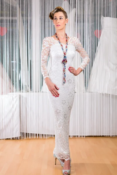 Woman trying wedding dress in shop — Stock Photo, Image