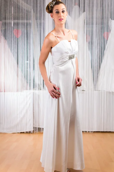 Woman trying wedding dress in shop — Stock Photo, Image