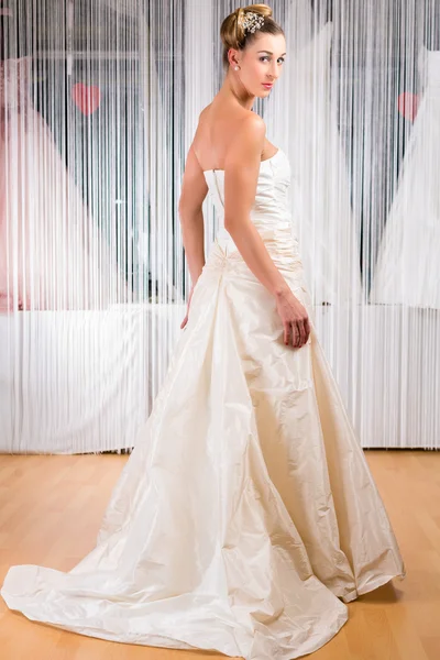 Woman trying wedding dress in shop — Stock Photo, Image