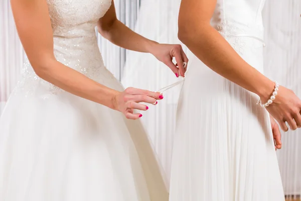 Brides at wedding dress fitting in shop — Stock Photo, Image