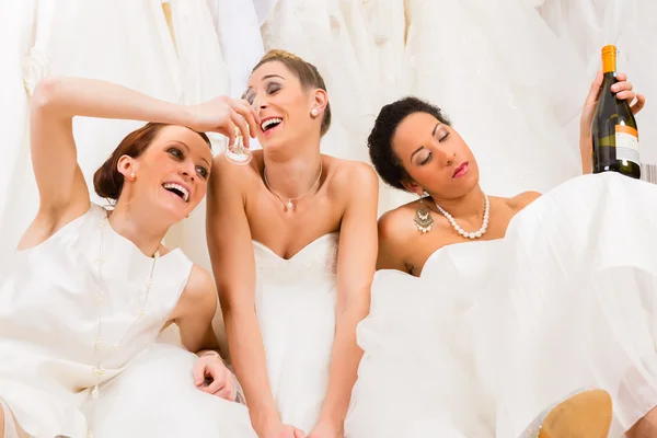 Brides drinking too much in wedding shop or store — Stock Photo, Image