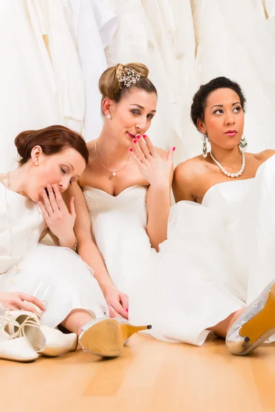 Brides drinking too much champagne in wedding shop — Stock Photo, Image