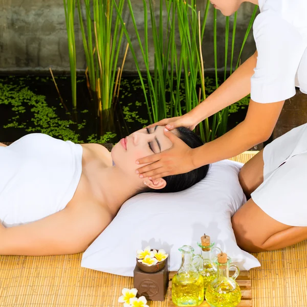 Asian woman having a massage in tropical setting — Stock Photo, Image