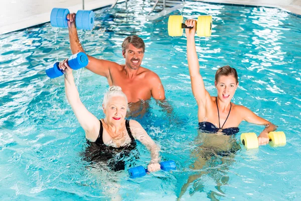 Group of people at water gymnastics or aquarobics