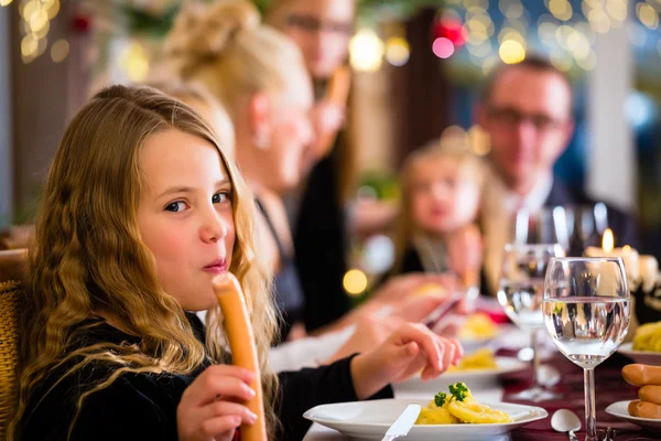 Οικογένεια τρώει λουκάνικα Χριστούγεννα για δείπνο — Φωτογραφία Αρχείου
