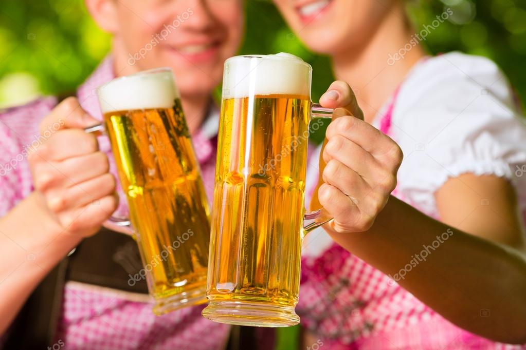 Happy Couple in Beer garden drinking beer — Stock Photo © Kzenon 83110842