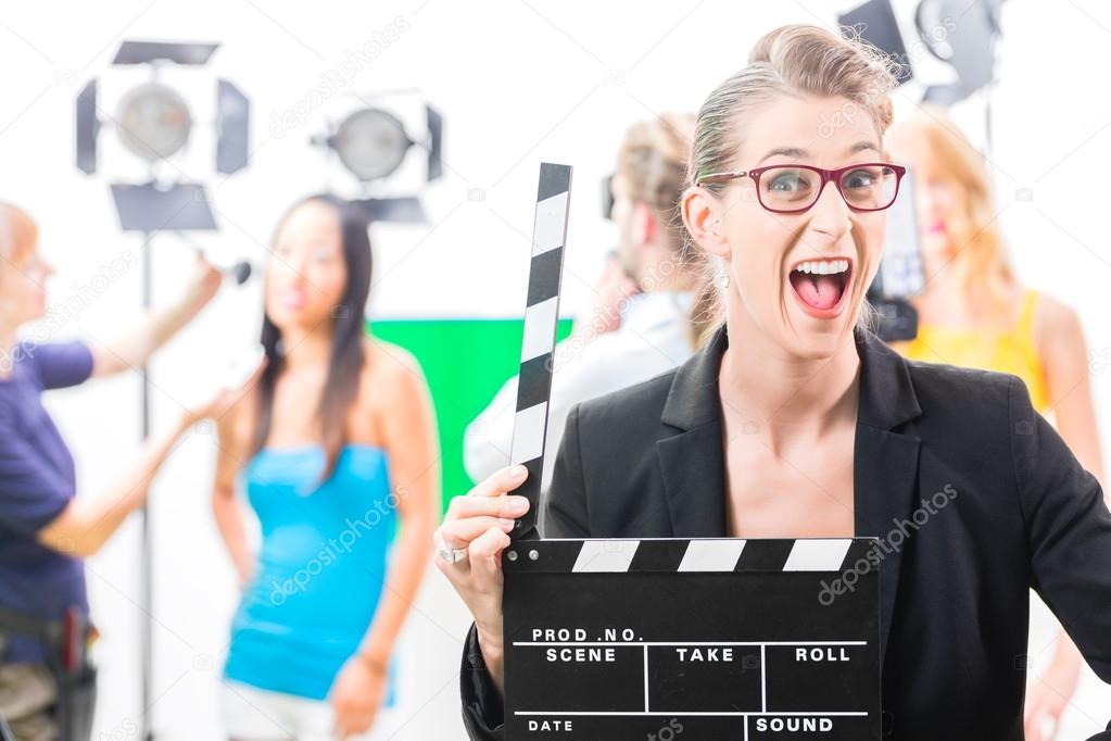 Woman with take clap at video production on film set