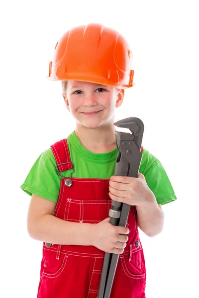 Lilla builder i hjälm med skiftnyckel — Stockfoto