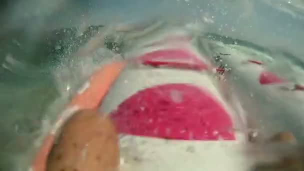 Banana inflável flutuando com salpicos no mar — Vídeo de Stock