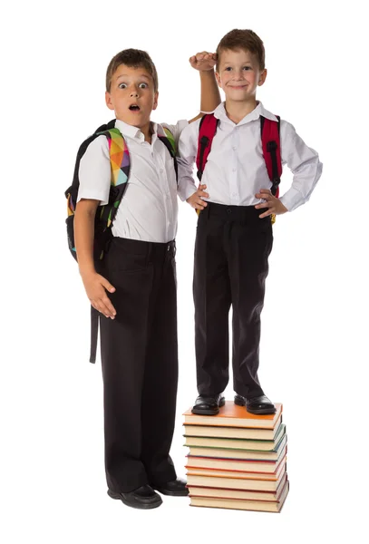 Two schoolboys standing with pile of books Stock Image