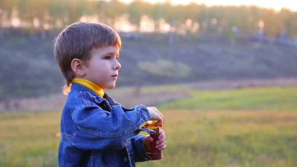 Boy blowing a soap bubbles — Stock Video