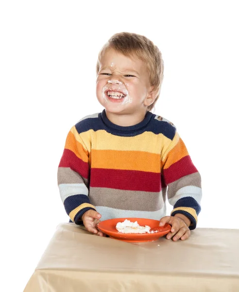 Dirty faced boy with cake showing his teeth, isolated on white — Stock Photo, Image