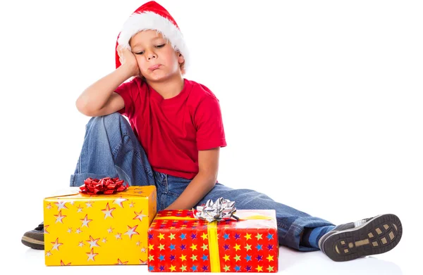 Trauriger Junge mit Geschenkschachtel in Weihnachtsmütze — Stockfoto