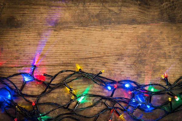Luces de Navidad sobre fondo de madera —  Fotos de Stock