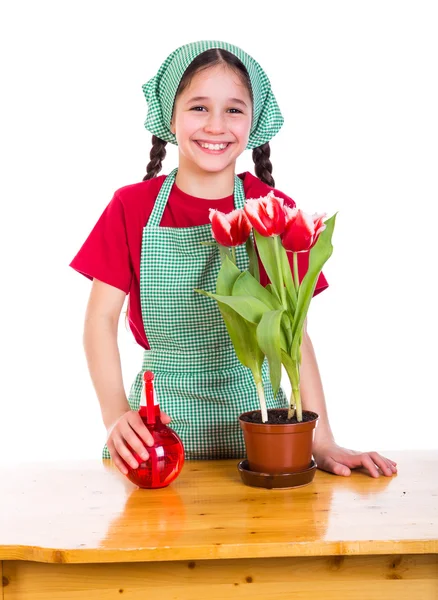 Menina cuidar flores no pote — Fotografia de Stock