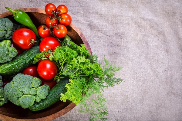 Vegetables on wooden plate with copy space — Stock Photo, Image
