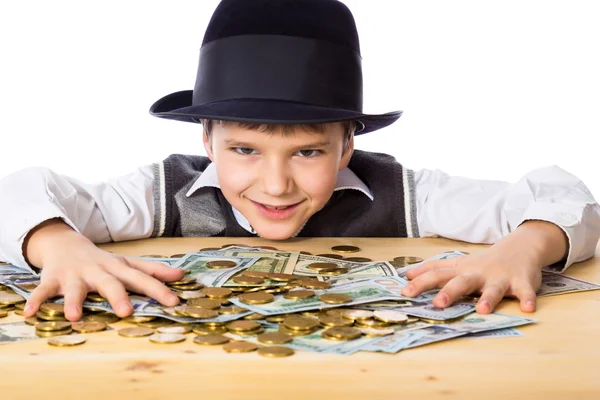 Happy boy with money on the table — Stock Photo, Image