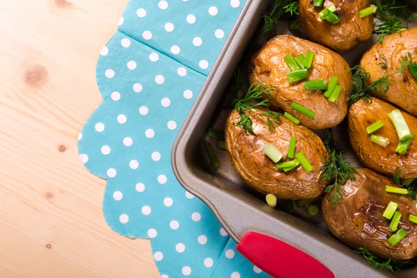 Baked potatoes with onion in tray — Stock Photo, Image