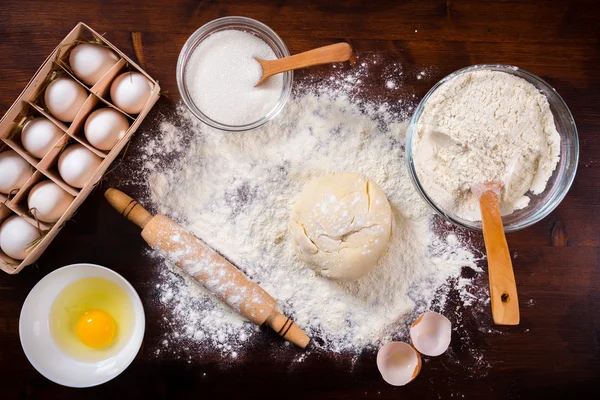 Baking ingredients on dark table — Stock Photo, Image