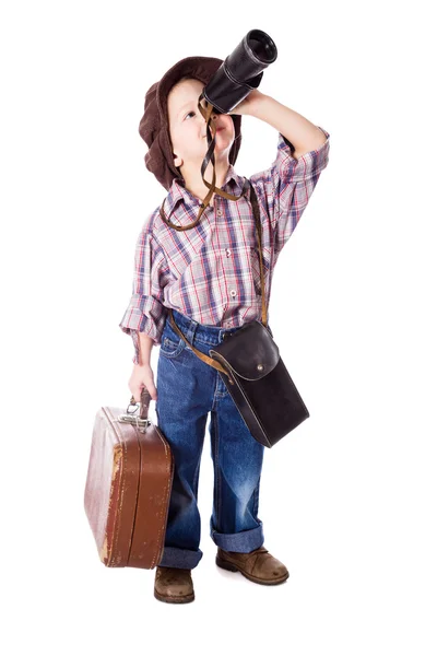 Boy with suitcase looking to spyglass — Stock Photo, Image