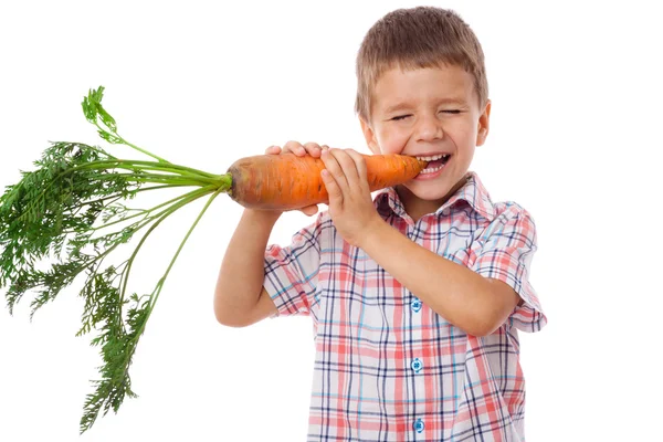 Little boy biting the carrot — Stock Photo, Image