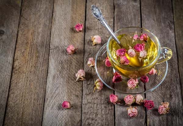 Tasse grüner Tee mit getrockneten Rosen — Stockfoto