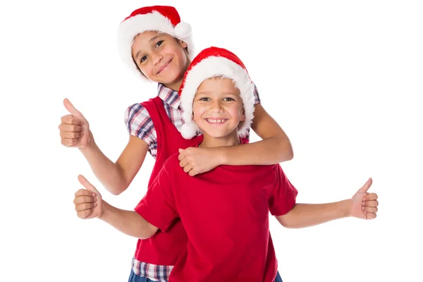 Dvě děti v vánoční čepice dohromady — Stock fotografie