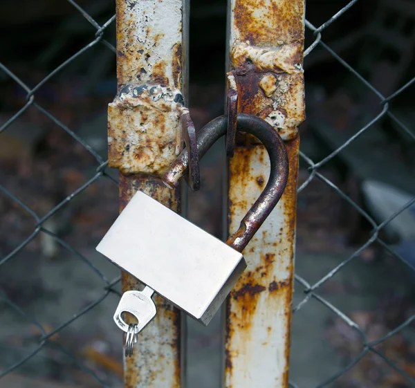 Old rustic steel lock on gate — Stock Photo, Image
