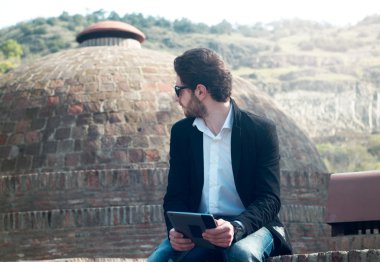 genç adam açık havada tablet ile sakallı