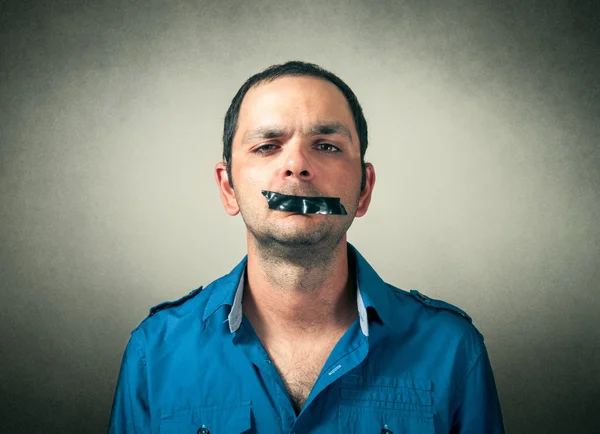 Portrait of man with the taped mouth — Stock Photo, Image