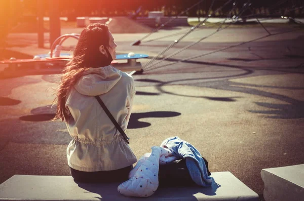 子供の遊び場に座っている女性 — ストック写真