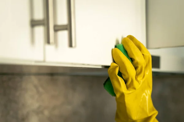 Hand with gloves washing in kitchen